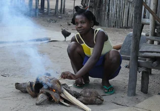 Renate Horak, starting a fire - Madagascar, Africa