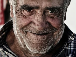 Portrait of a friendly smiling man whistling on the street.