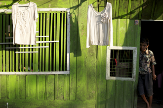 Christina Feldt, Boy in front of green house, Myanmar.