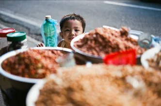 Photo art by Jim Delcid: child enjoying street food in Iloilo, Philippines.