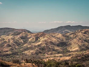 Photo art by Johann Oswald: gentle hills and mountains in Costa Rica under sunlight.
