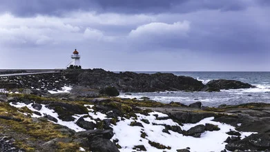 Photo art by Christian Schipflinger: lighthouse by the sea under a cloudy sky
