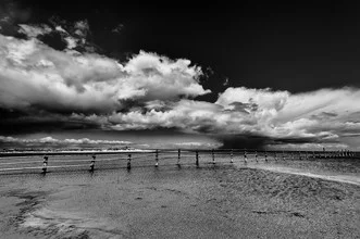 Photo art by Mario Ebenhöh: fence against a sky with soft clouds in the background.
