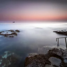 Photo art by Ronnie Baxter: ships at dusk near rocky coastline