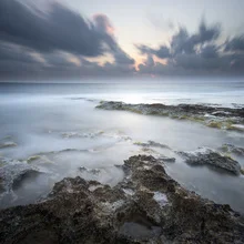 Photo art by Ronnie Baxter: calm sunset over Cyprus' rocky coastline