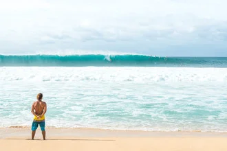 Photo art: Surfer riding a wave in the ocean at sunset on Oahu, Hawaii.