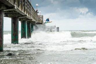 Photo art by Lars Jacobsen: Surfer riding a wave at the Baltic Sea
