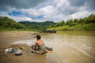 Photo art by Miro May: calm river in Bangladesh, surrounded by gentle hills.