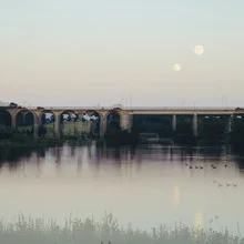 Photo art depicts Obersee in Bielefeld with a bridge and double exposure under the moon.