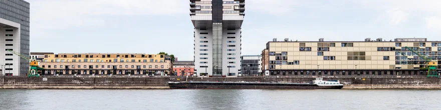 Photo art by Jörg Faißt: view of the Cologne riverside with calm water and urban atmosphere