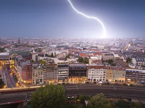 Night photo of a thunderstorm over a cityscape with lightning
