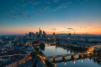 Photo art by Robin Oelschlegel: Frankfurt skyline with buildings in a warm sunset glow