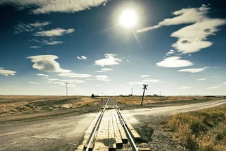 Photo art by Arthur Selbach: rural scene with a power pole and railway tracks in backlight