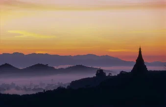 Beautiful photo art: mist-covered mountains at sunrise in Myanmar.