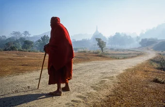 Resting monk in Myanmar, a serene moment captured in soft colors.