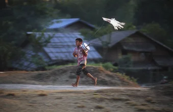 Photo art by Martin Seeliger: boy flying a plastic bag kite in Myanmar