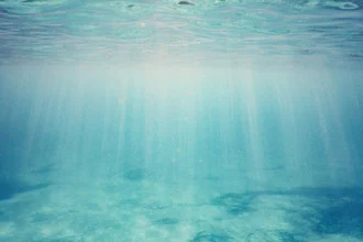 Photo art by Nadja Jacke: Sunbeams underwater in a blue sea