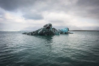 Photo art by Norbert Gräf: shimmering glacial lake in Iceland under clear skies