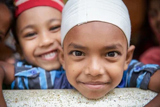 Photo art by Miro May: cheerful boys in front of a mosque in Srimangal, Bangladesh.