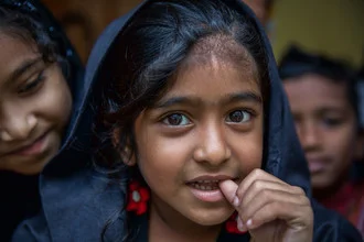 Photo art by Miro May: smiling girl in front of a madrasa in Srimangal