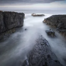 Photo art by Ronnie Baxter: rocks under a cloudy sky in Northumberland