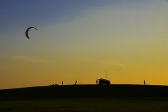 Photo art by Heiko Krumminga: Kite Skating at sunset on the beach
