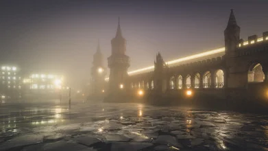 Fog envelops the Oberbaum Bridge, glowing softly in the evening light.