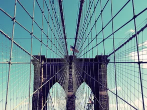 Photo art by Kay Block: view of a fishing net and the Brooklyn Bridge.
