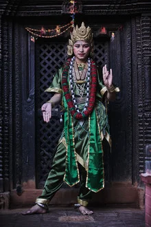 Portrait of a Newari girl from Nepal smiling in traditional clothing.