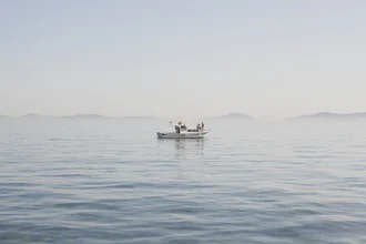 Photo art by Thomas Neukum: boat on a calm river at sunset