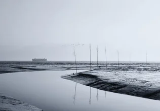 Photo art by Manuela Deigert: a ship on a calm waterway in the mudflats