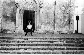 Photo art by Piero Chiussi: Child playing football on church stairs in Apulia.