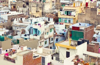 Colorful houses of Udaipur, India, arranged harmoniously under a clear sky.