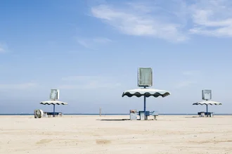 Lovely picnic area with umbrellas and blue sky in Oman