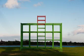 Photo art by Jac Kritzinger: children playing on monkey bars in a joyful setting