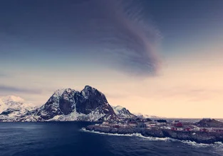 Photo art by Franz Sussbauer: Cloud formation over rocks at a winter bay in Norway