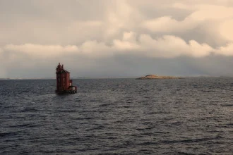 Photo art by Dr. Christa Oppenheimer: lighthouse in the sea near Norwegian coastline