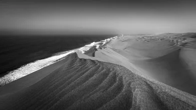 Photo art by Dennis Wehrmann: long wall at Sandwich Harbor with desert dunes in the background