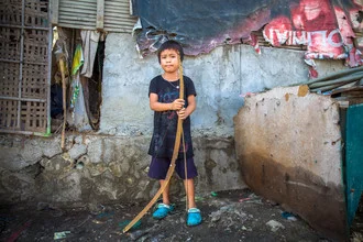 Photo art by Miro May: A boy with a bow in a city view of the Philippines.