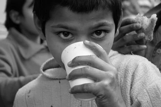 Portrait of a boy with expressive eyes, warm light, and a gentle mood.