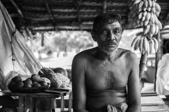 Portrait of an old Sri Lankan man in his curry shack, captured in black and white.