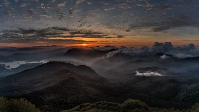 Sunrise over Adams Peak in Sri Lanka, soft colors on the horizon