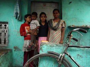 Photo art by Jagdev Singh: group of girls with a bicycle in a slum