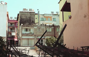Bright street scene in Ortaca, Turkey with colorful houses and a welcoming courtyard.