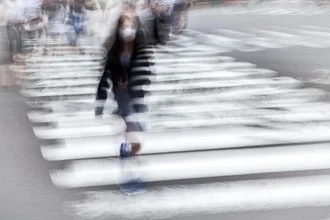 Photo by Jörg Faißt: People walking across a crosswalk in Kyoto.