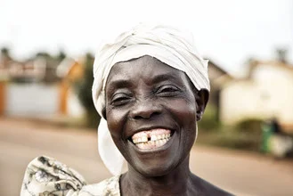 Smiling African woman in Jinja, Uganda, radiating joy.
