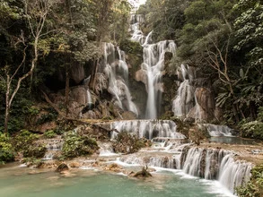 Waterfall in the jungle of Laos: gentle flow and lush greenery