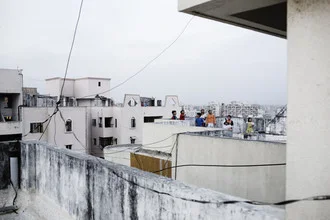 Photo art by Enok Holsegaard: Kids playing on a rooftop during a festival in India.