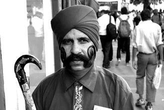 Photo art by Vijay Koul: Guard proudly displaying his moustaches in Delhi.