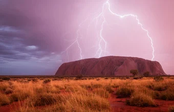 Wall art by Christoph Schaarschmidt: view of Uluru during a stormy atmosphere
